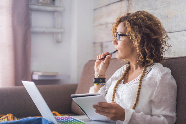 woman thinks before writing